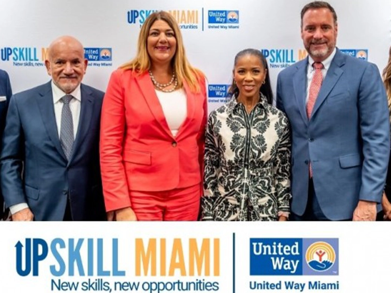 4 people posing and smiling at the camera