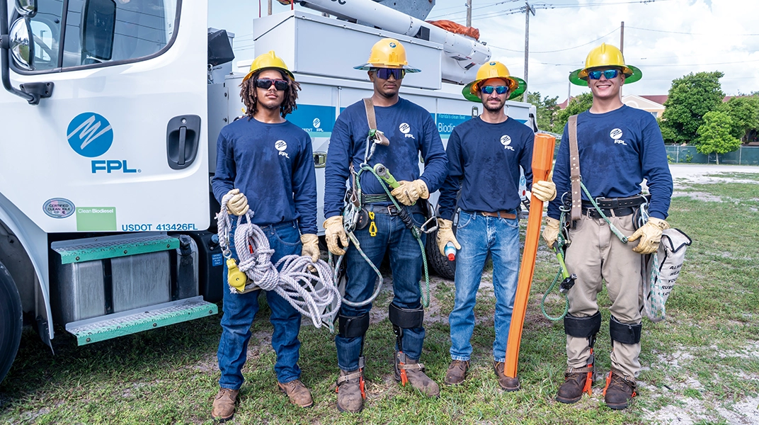 group of men wearing yellow helmets, working