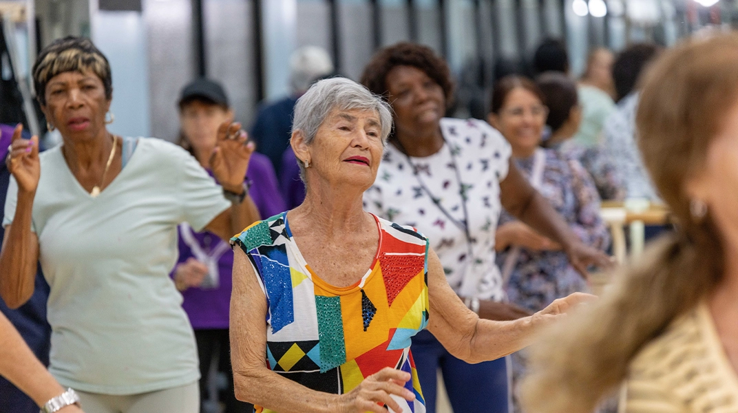 older adult dancing with other people