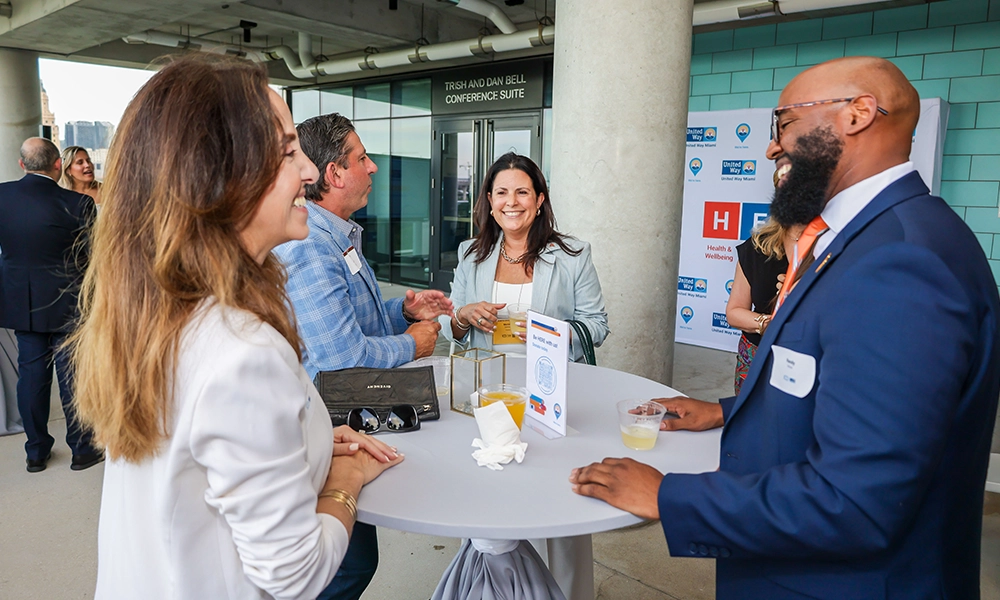 five people talking during an event