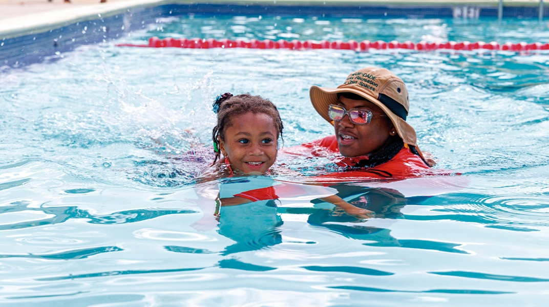 woman swimming with little girl